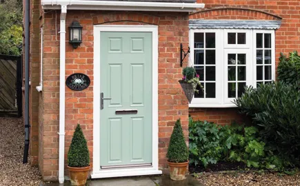 Light green Everest conservatory door with white trim and plants