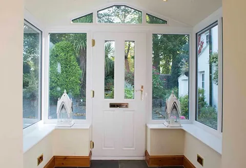 White Everest conservatory entrance with windows and door