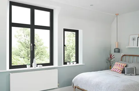 Black framed windows in a light blue room