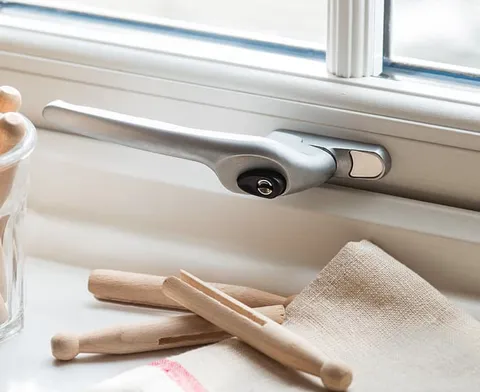 Silver window handle on white Everest conservatory window