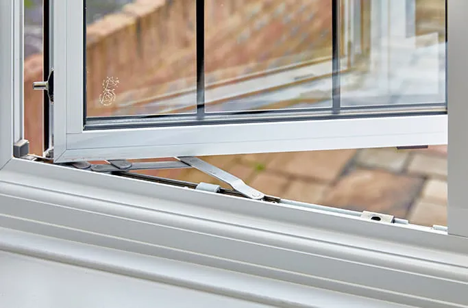 Everest conservatory window detail with white frame and metal hinges