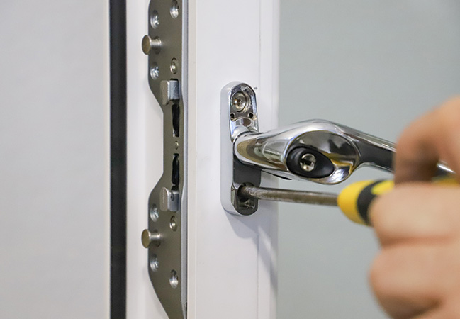 Person using screwdriver to fix Everest conservatory door lock