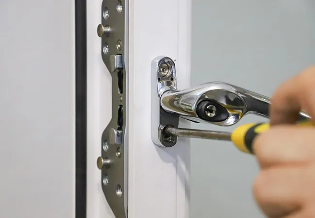 Person using screwdriver to fix Everest conservatory door lock