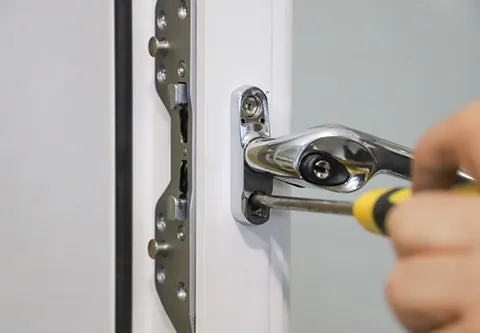 Person using screwdriver to fix Everest conservatory door lock