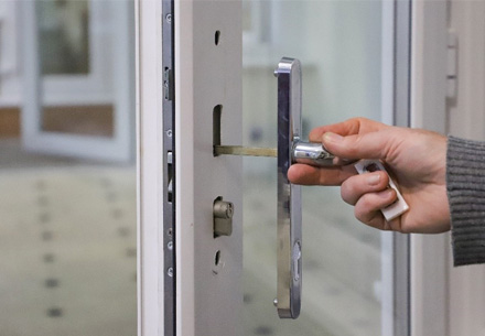 Person unlocking Everest conservatory door with chrome handle