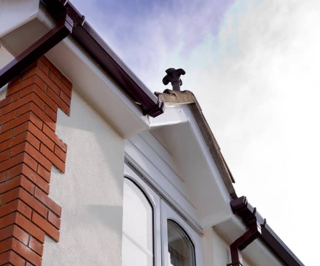 Everest conservatory with white fascia and brown guttering