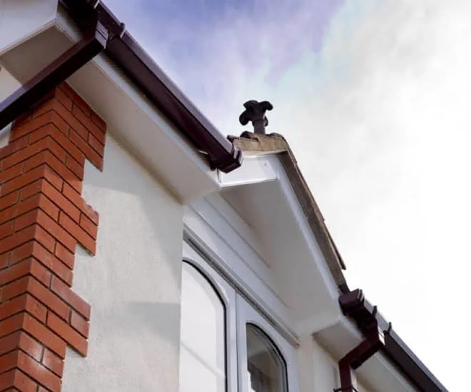 Everest conservatory with white fascia and brown guttering