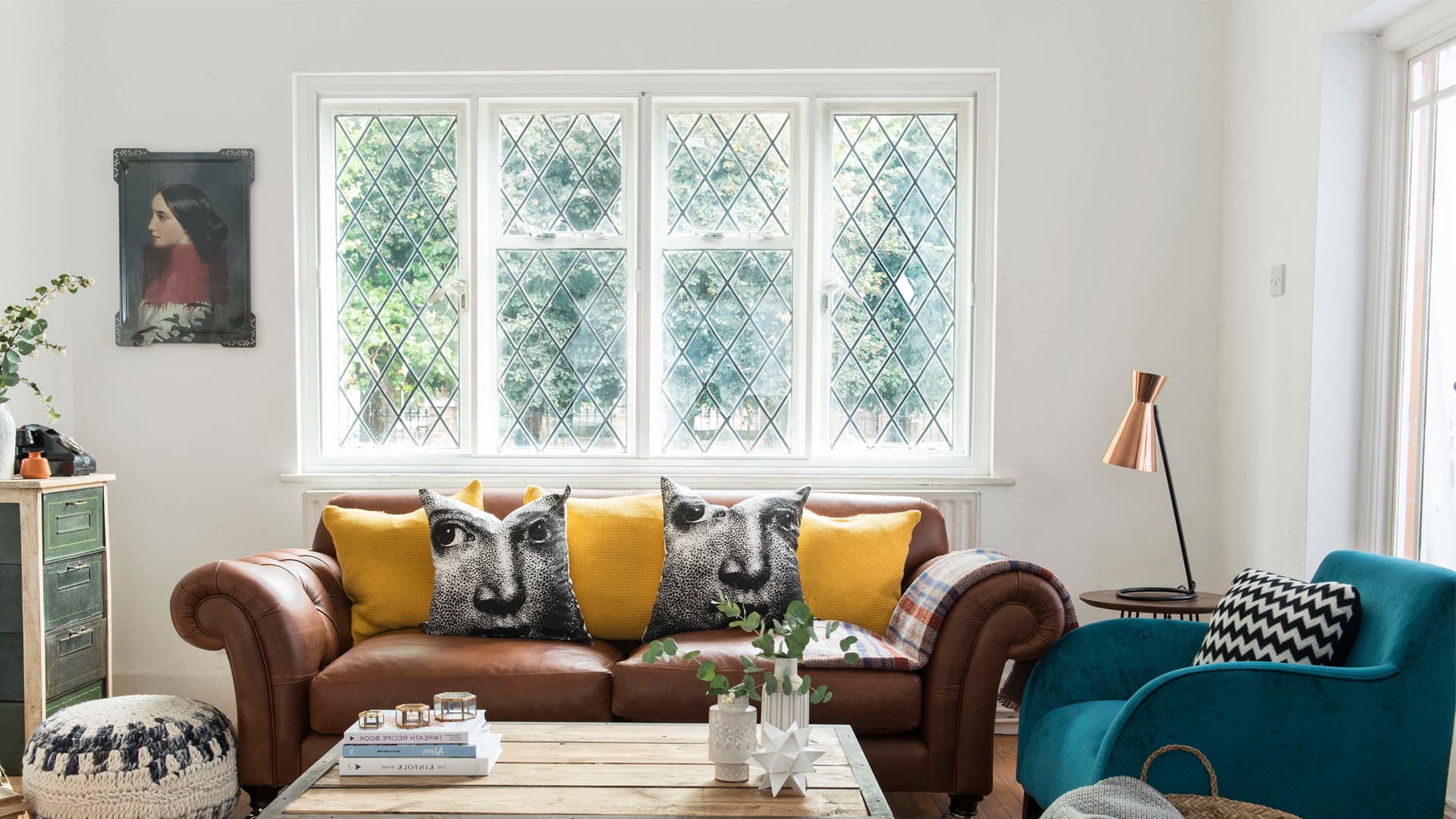 Brown leather sofa with yellow and black patterned cushions