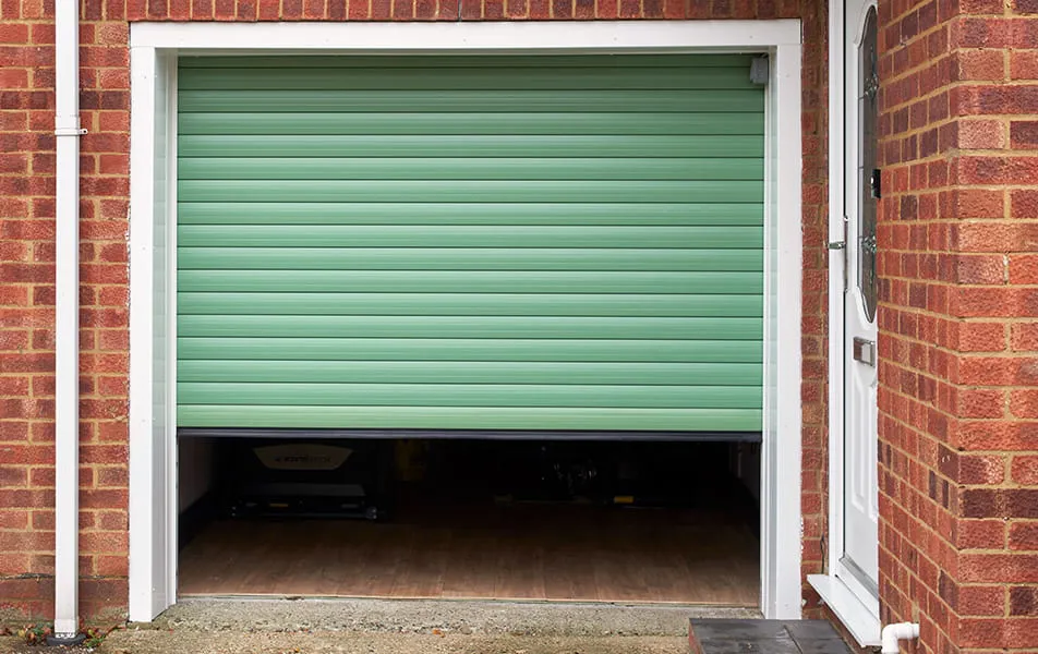 Open light green garage door with a light brown floor