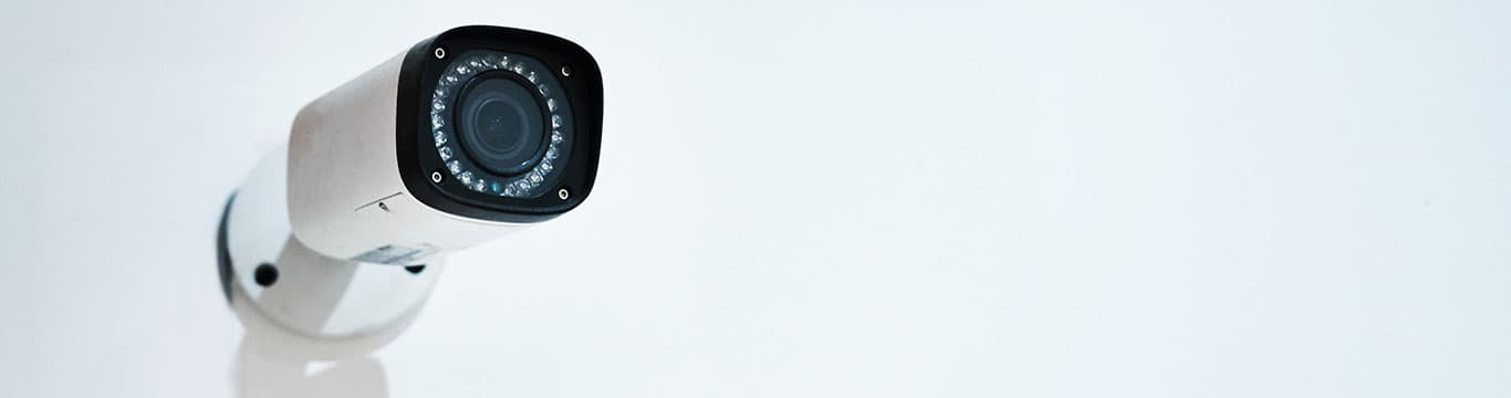 White security camera mounted on wall