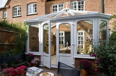 Everest conservatory with light grey panels and glass doors open