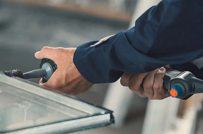 Person cleaning Everest conservatory glass with tool