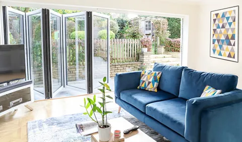 Everest conservatory with blue sofa and patterned cushions