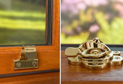 Gold window fasteners on a wooden Everest conservatory window