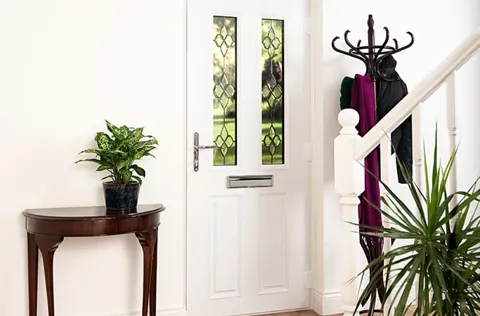 White door with decorative glass and plants