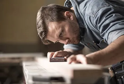 Man working on a Everest amdega door