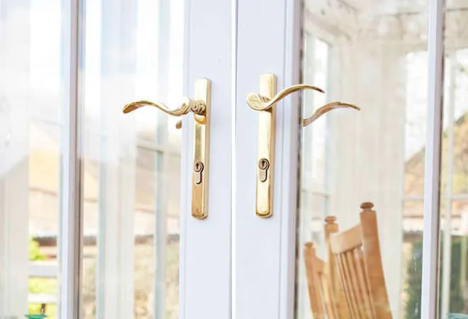 Gold handles on white Everest conservatory doors