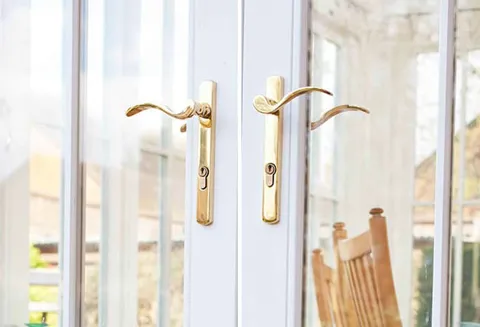 Gold handles on white Everest conservatory doors