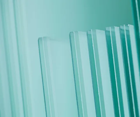 Close up of multiple sheets of light teal glass