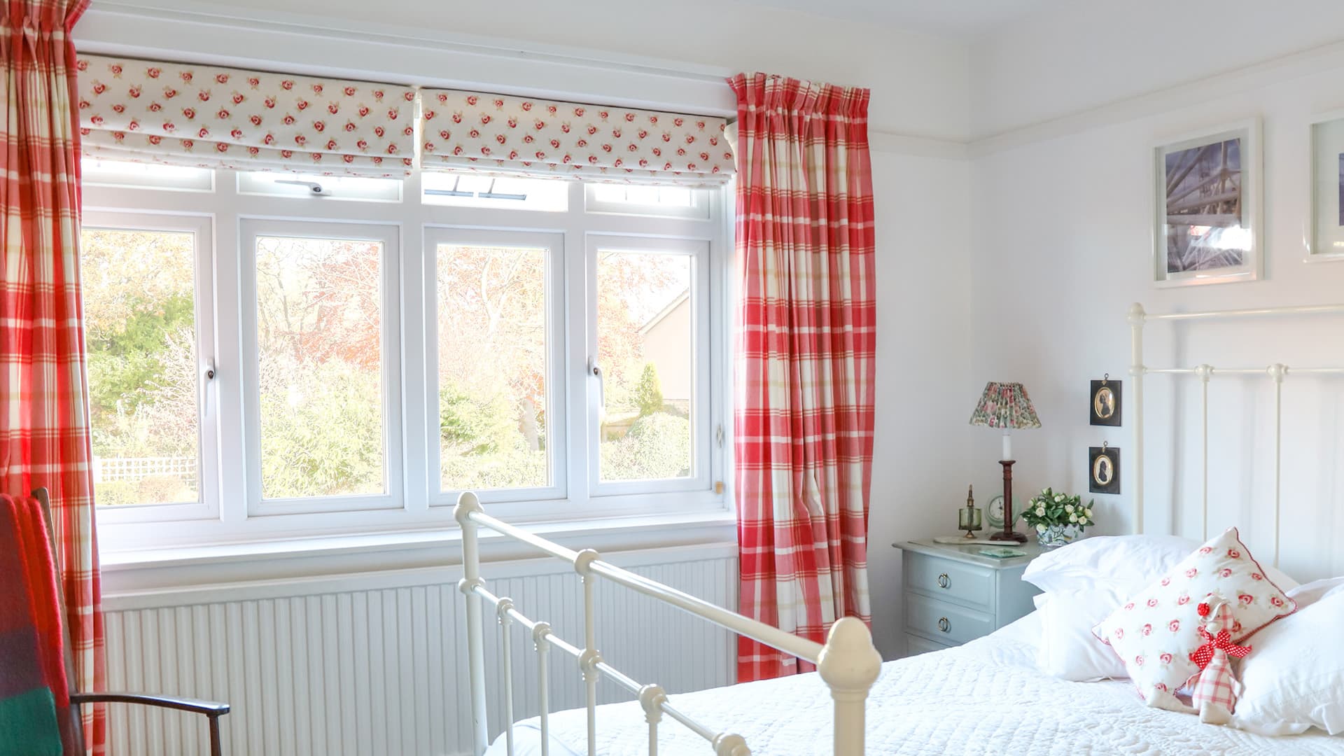 White bedroom with red and cream checkered curtains