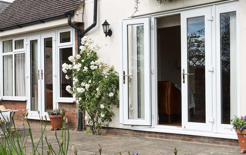 White Everest conservatory doors open onto patio