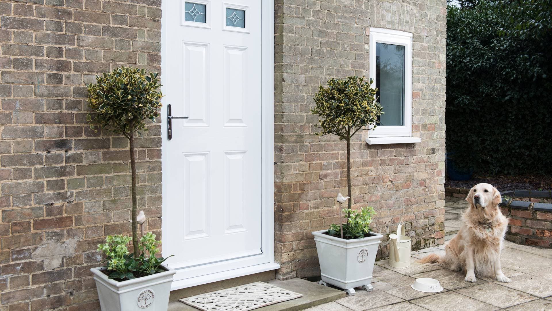 White door with brick exterior and plants