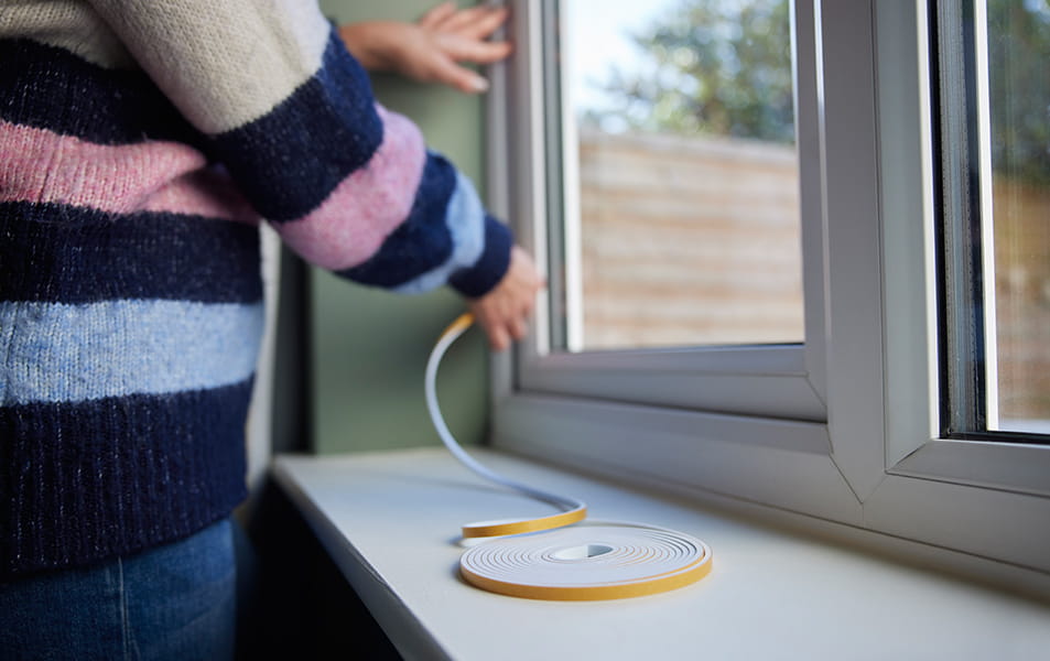Person installing window sealant on Everest conservatory window