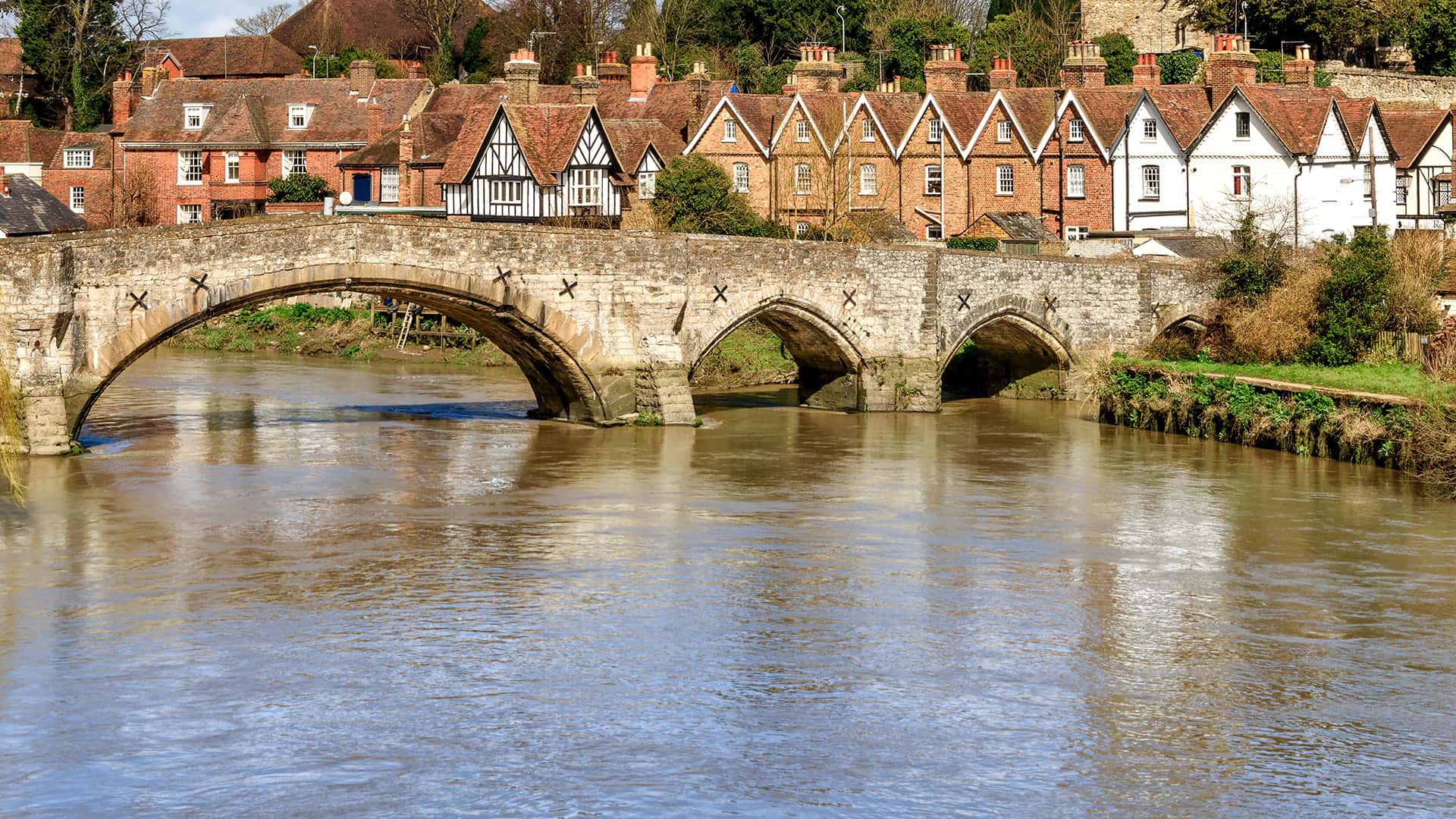 Stone bridge over a river with old houses