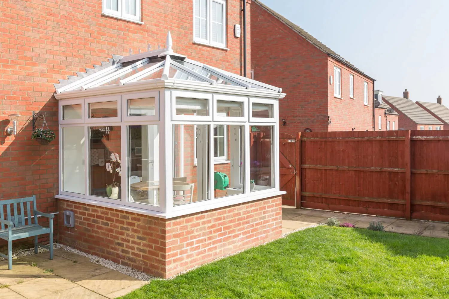 White Everest conservatory with brick walls and garden