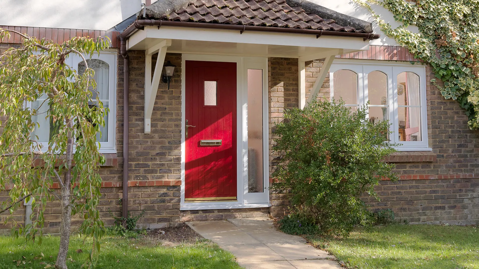 Red door on Everest conservatory with brick house