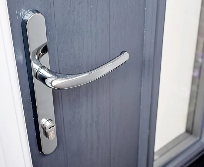 Chrome door handle on grey composite door