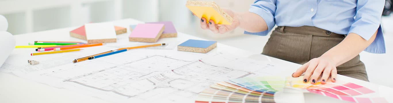 Person reviewing color swatches and blueprints