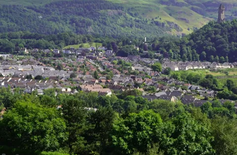 Houses and trees in a valley landscape