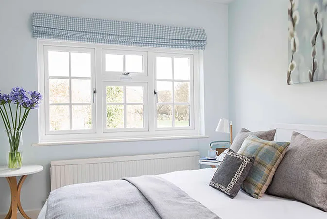 White Everest conservatory window with light blue patterned curtains