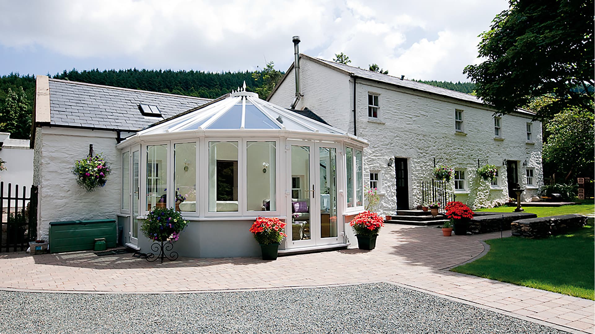 White Everest conservatory attached to a white stone house