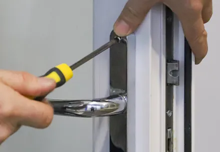 Person using screwdriver to fix Everest conservatory door handle