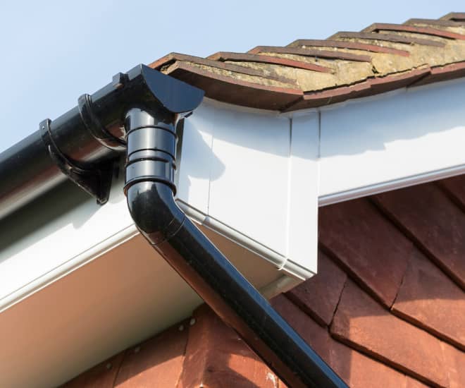 Black conservatory gutter on a white fascia board
