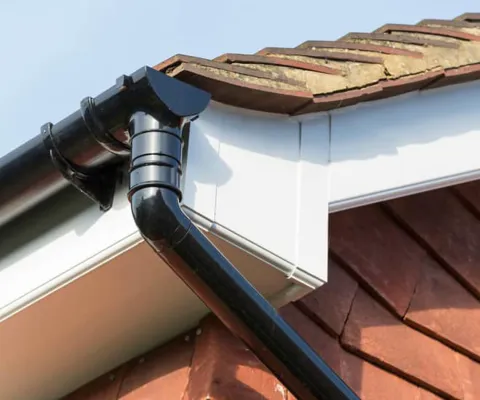 Black conservatory gutter on a white fascia board