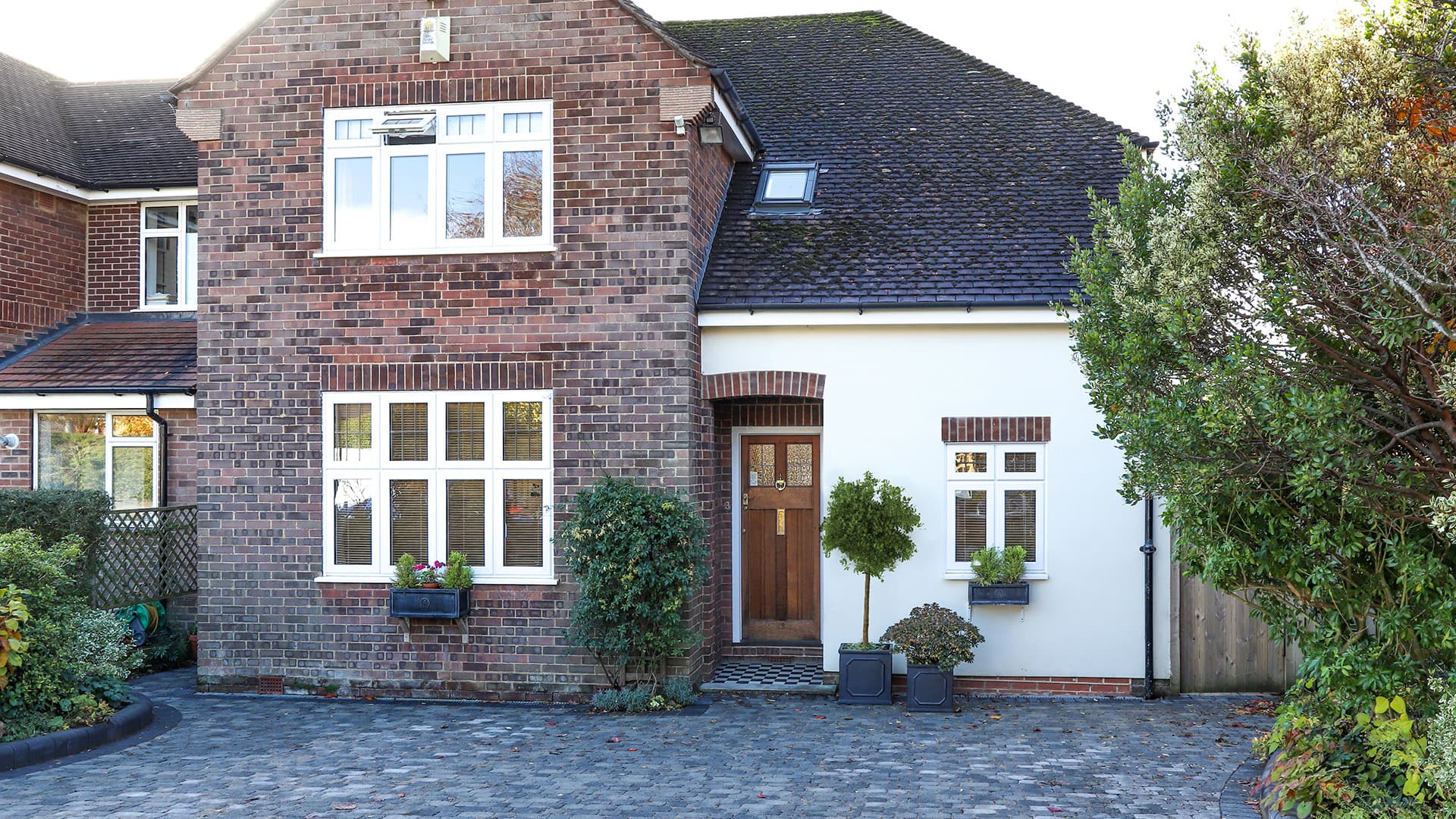 Brick house with white windows and a front door