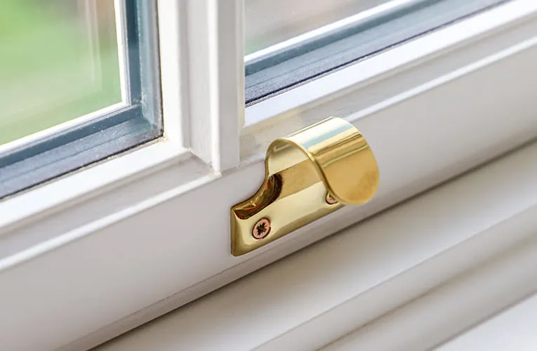 Gold window stay on white Everest conservatory window