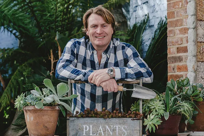 Man in plaid shirt standing in Everest conservatory