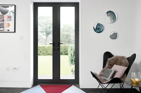 Black double doors with glass panels on Everest conservatory