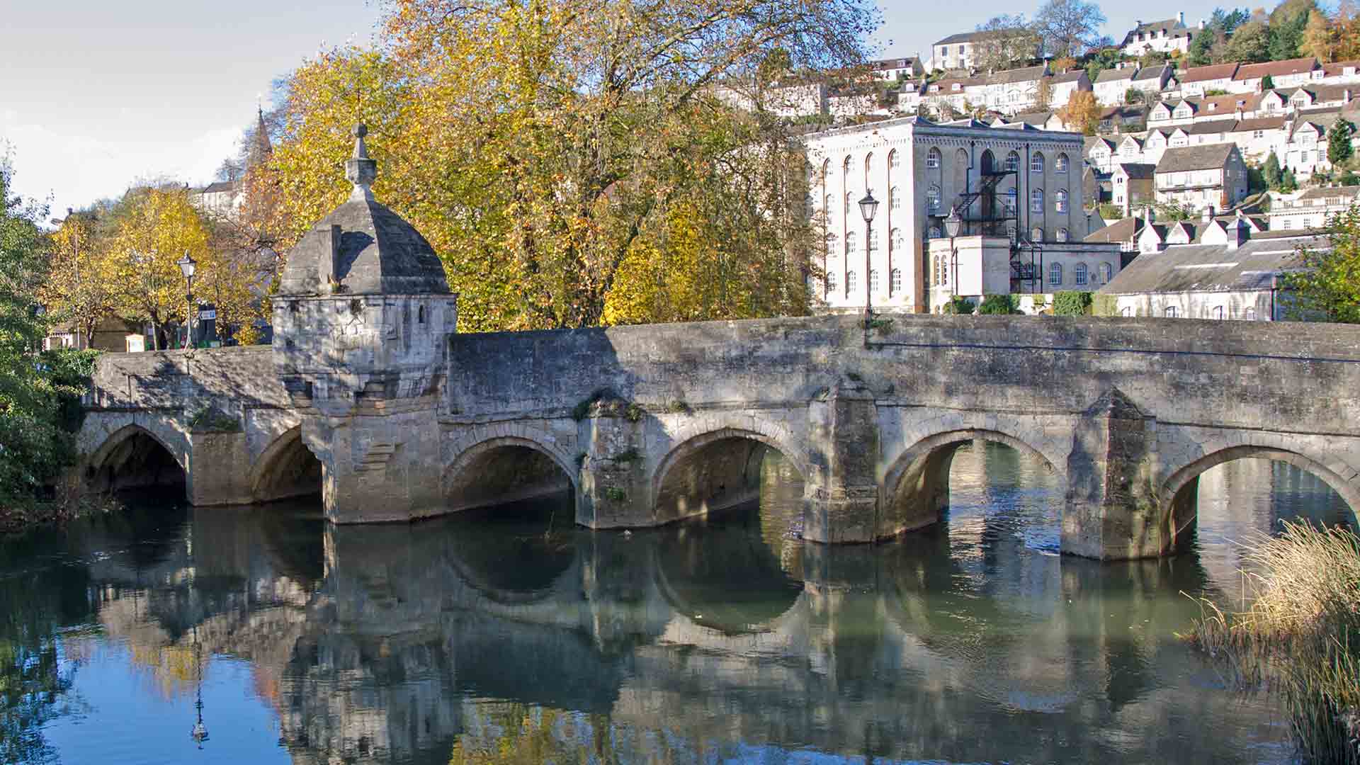 Stone bridge over river with arched openings