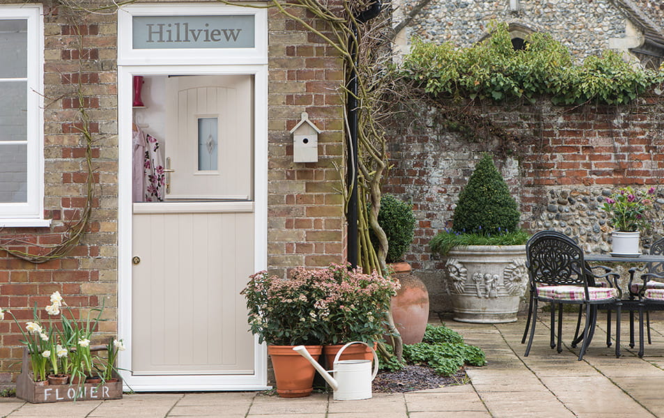 Light beige door with outdoor plants and pots