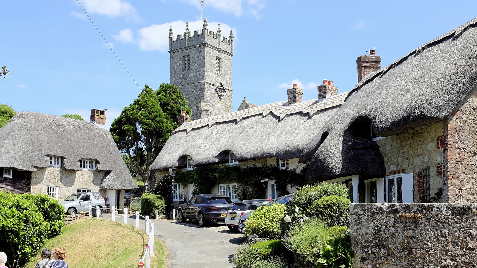 Thatched cottages and church in a village setting