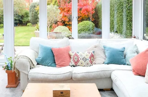 Everest conservatory with white sofa and colorful cushions