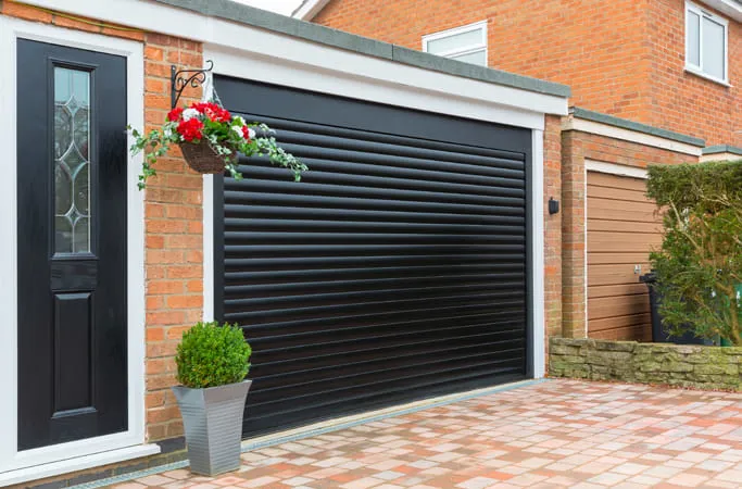 Black garage door with decorative flowers