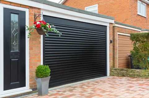Black garage door with decorative flowers