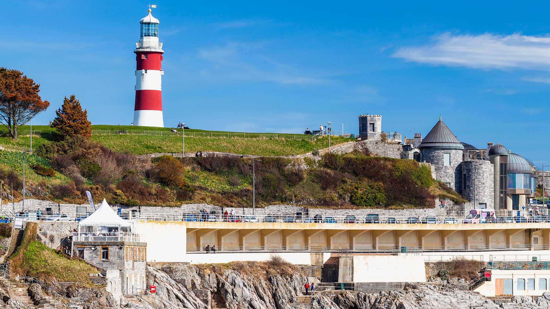 Coastal scene with red and white lighthouse