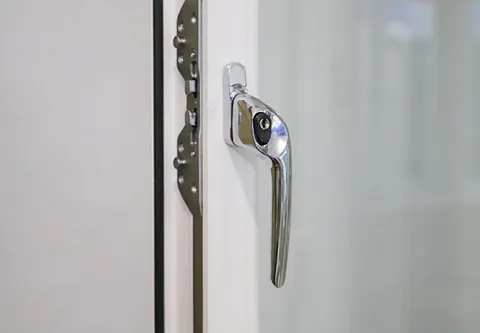 Chrome window handle on white Everest conservatory